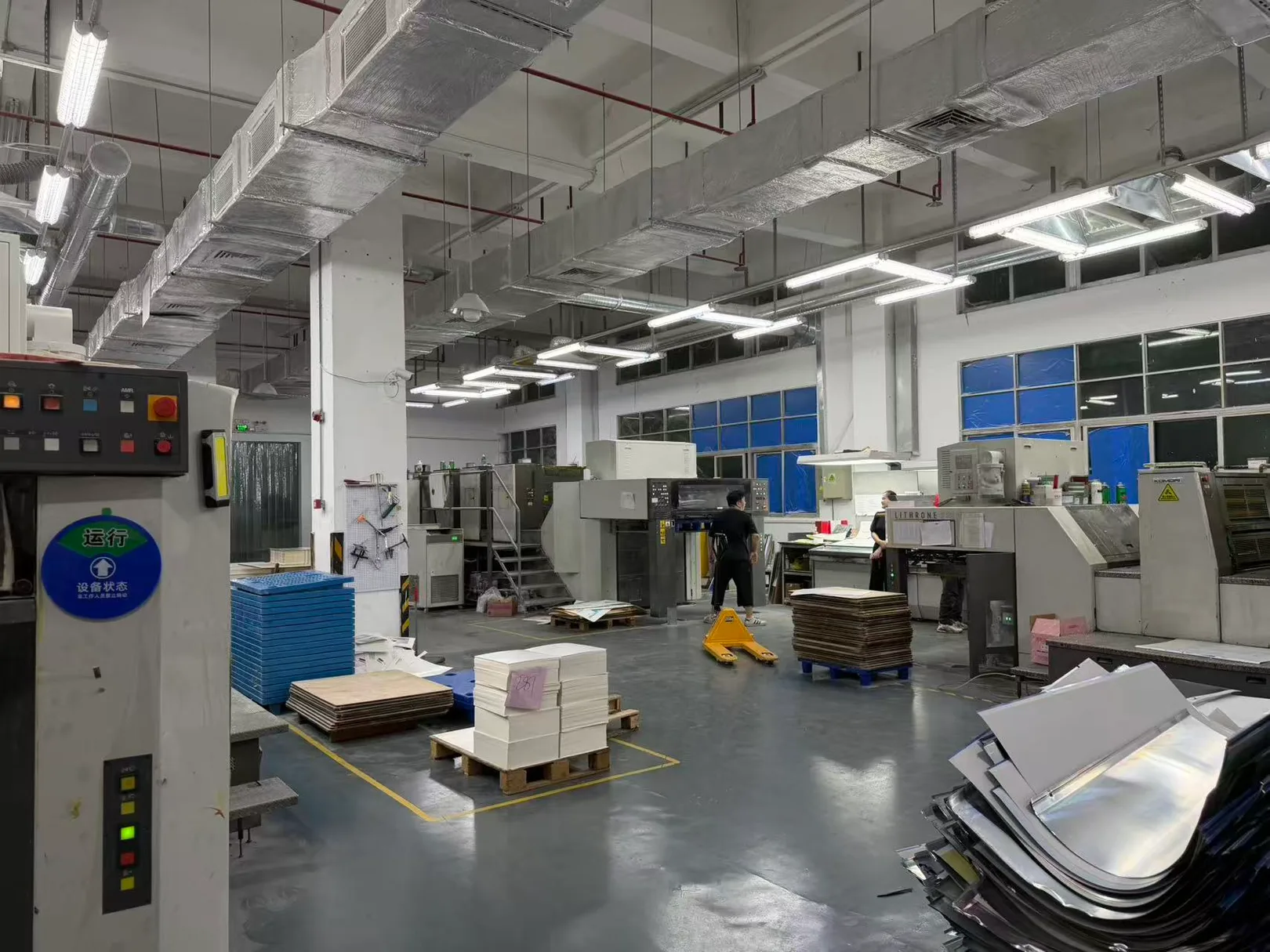 Full factory floor overview with packaging pallets and machinery
